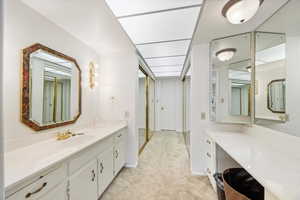 Full bathroom featuring vanity and light colored carpet