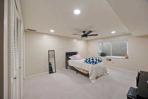 Carpeted bedroom featuring recessed lighting and a ceiling fan