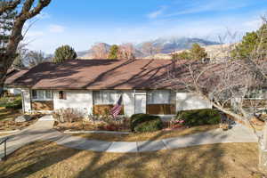 View of front of home featuring a shingled roof and a mountain view