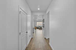 Hallway featuring light wood-type flooring and recessed lighting