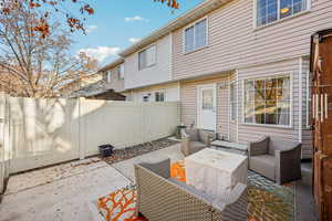 Fenced backyard featuring a patio and an outdoor living space