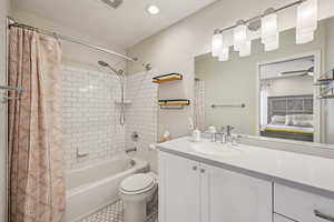 Ensuite bathroom with shower / bath combination with curtain, vanity, and tile patterned floors