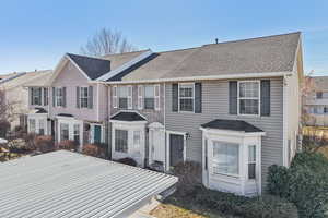 View of front facade featuring roof with shingles