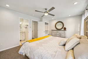 Bedroom featuring carpet floors, ceiling fan, recessed lighting, and ensuite bath