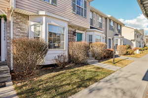 View of home's exterior featuring a yard and a residential view