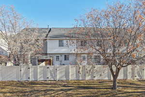 Back of property featuring a gate and roof with shingles