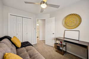 Living area featuring light colored carpet and baseboards