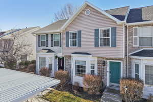 Traditional home featuring a shingled roof