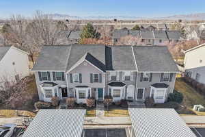 View of front of house with uncovered parking, a residential view, a mountain view, and roof with shingles