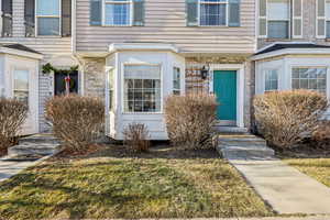 Entrance to property with a lawn