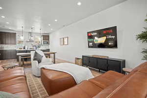 Living area with recessed lighting and light wood-style flooring