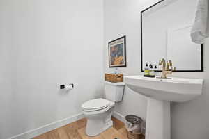 Half bathroom featuring baseboards and light wood-type flooring