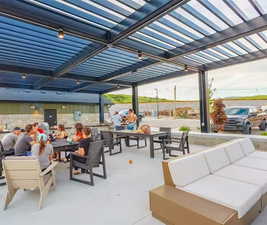 View of patio featuring an outdoor hangout area and a pergola