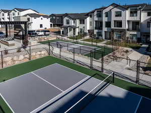 Surrounding community featuring a tennis court, a gate, and a pergola
