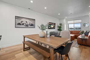 Dining space with light wood-style flooring and recessed lighting