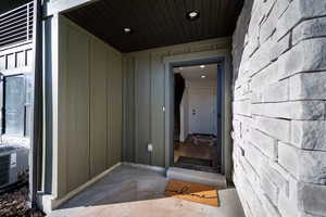 Doorway to property featuring board and batten siding