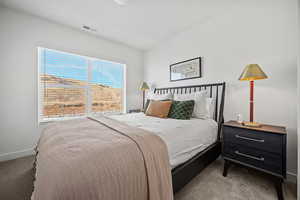 Bedroom featuring carpet flooring and baseboards