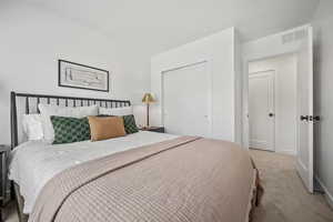 Carpeted bedroom featuring a closet