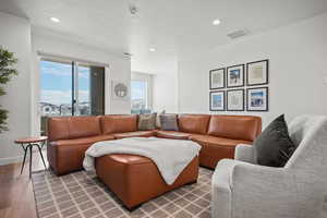 Living room with recessed lighting and wood finished floors