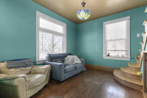 Sitting room featuring hardwood / wood-style flooring and a textured ceiling