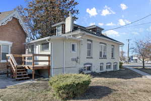 View of property exterior with a chimney and brick siding