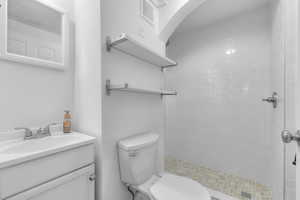 Full bath with a shower stall and vanity