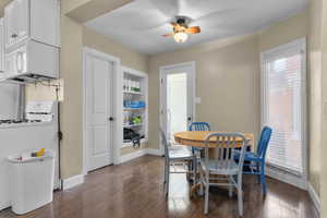 Dining area featuring dark wood finished floors and a ceiling fan