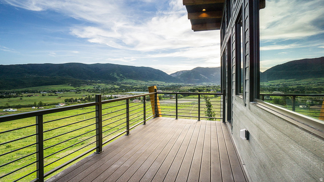 Wooden terrace featuring a mountain view