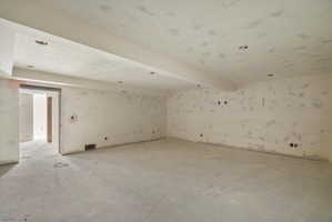 Spacious unfinished interior area with a concrete floor, recessed lighting, and multiple wall outlets