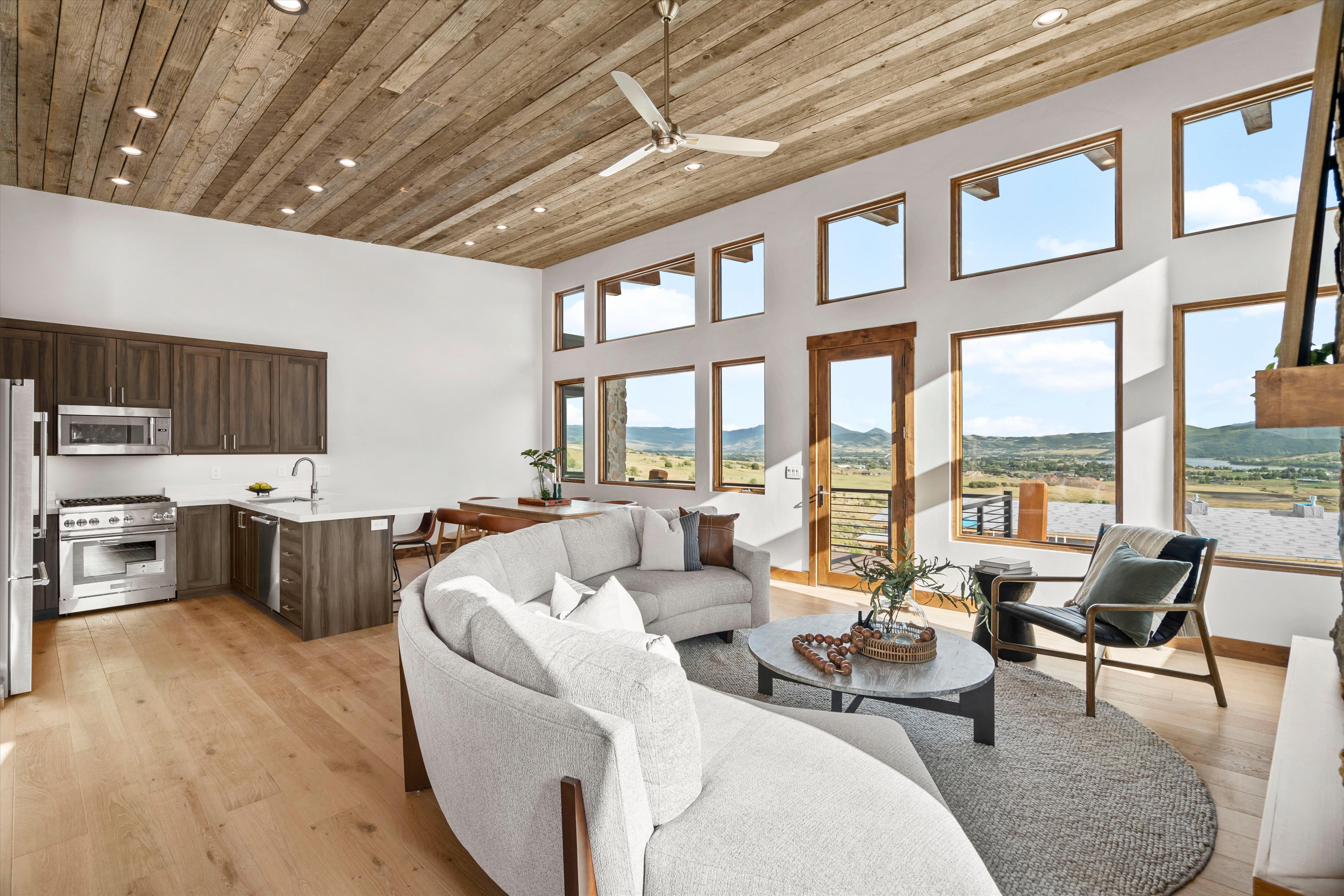 Vaulted wood-plank ceiling with recessed lighting and a ceiling fan