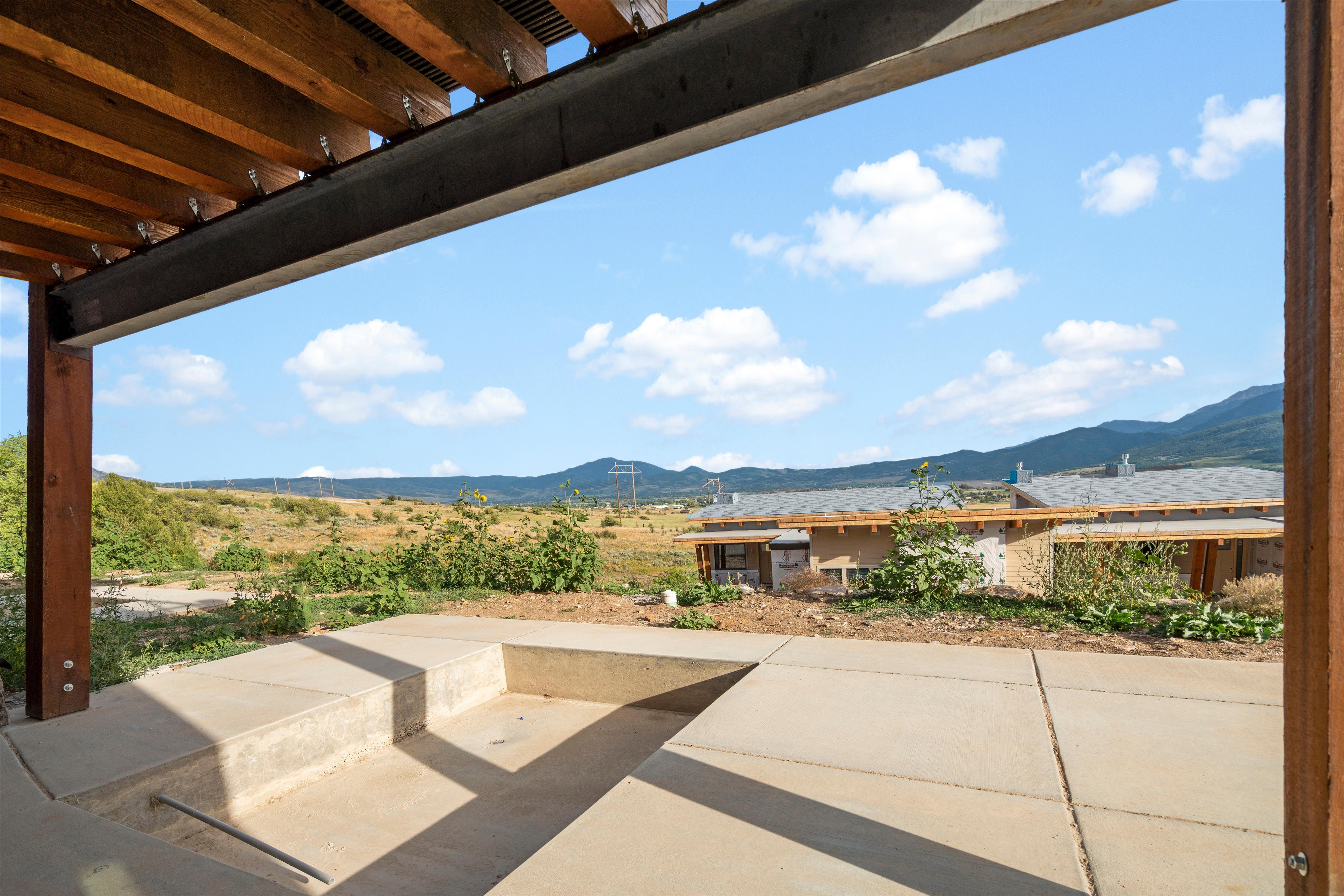 Expansive concrete patio featuring built-in steps and a sunken area
