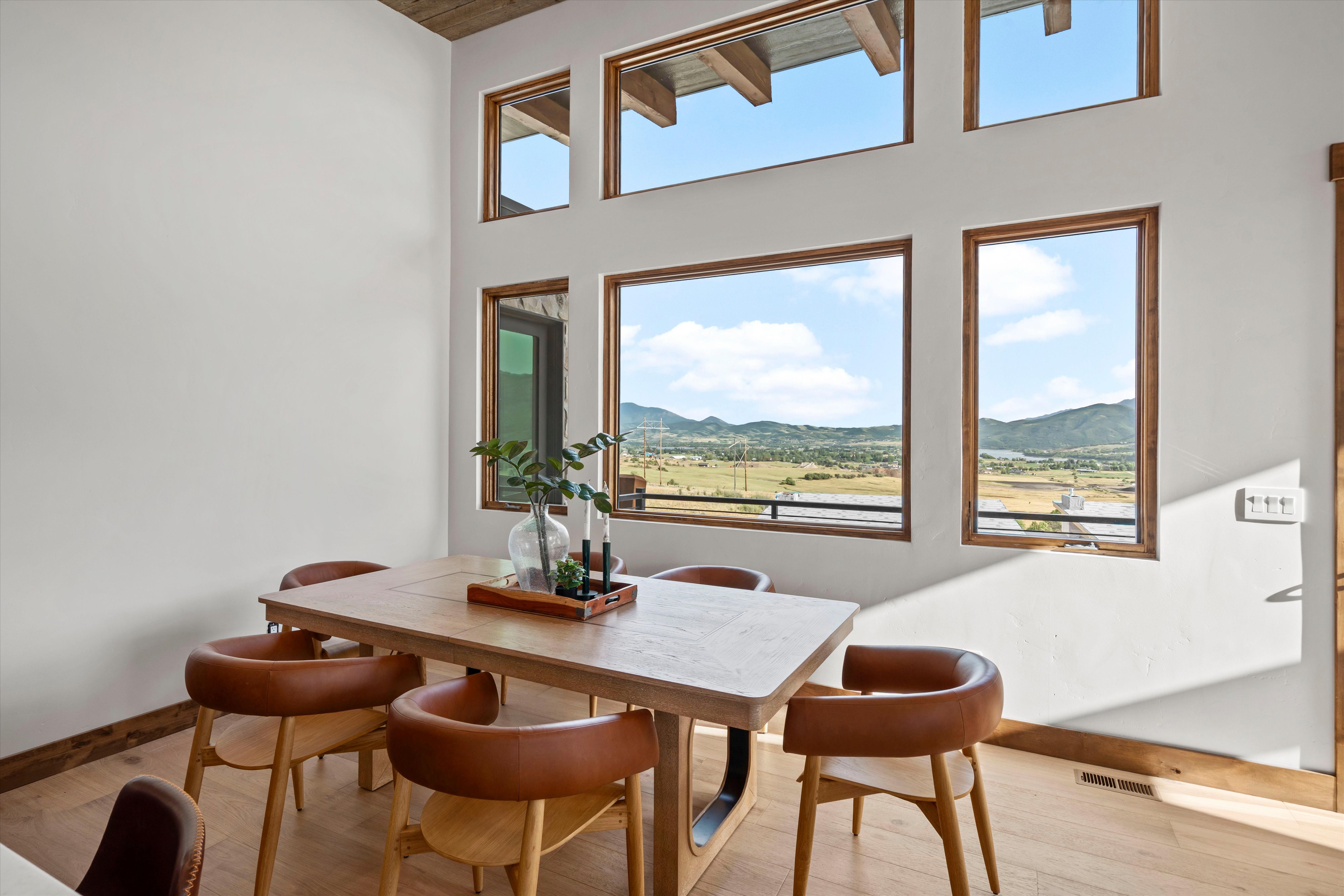 High ceilings complement extensive window placements, showcasing expansive outdoor scenery