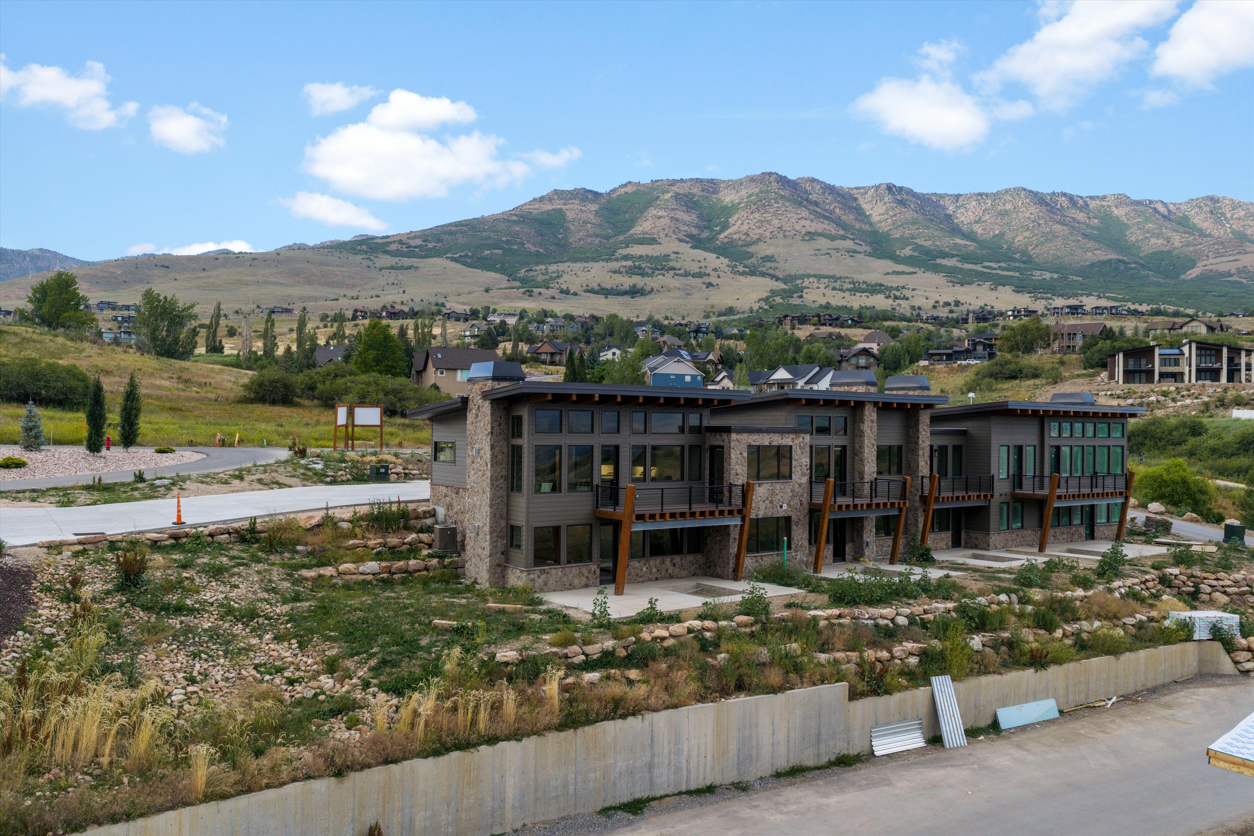 Modern architectural design featuring stone and dark siding