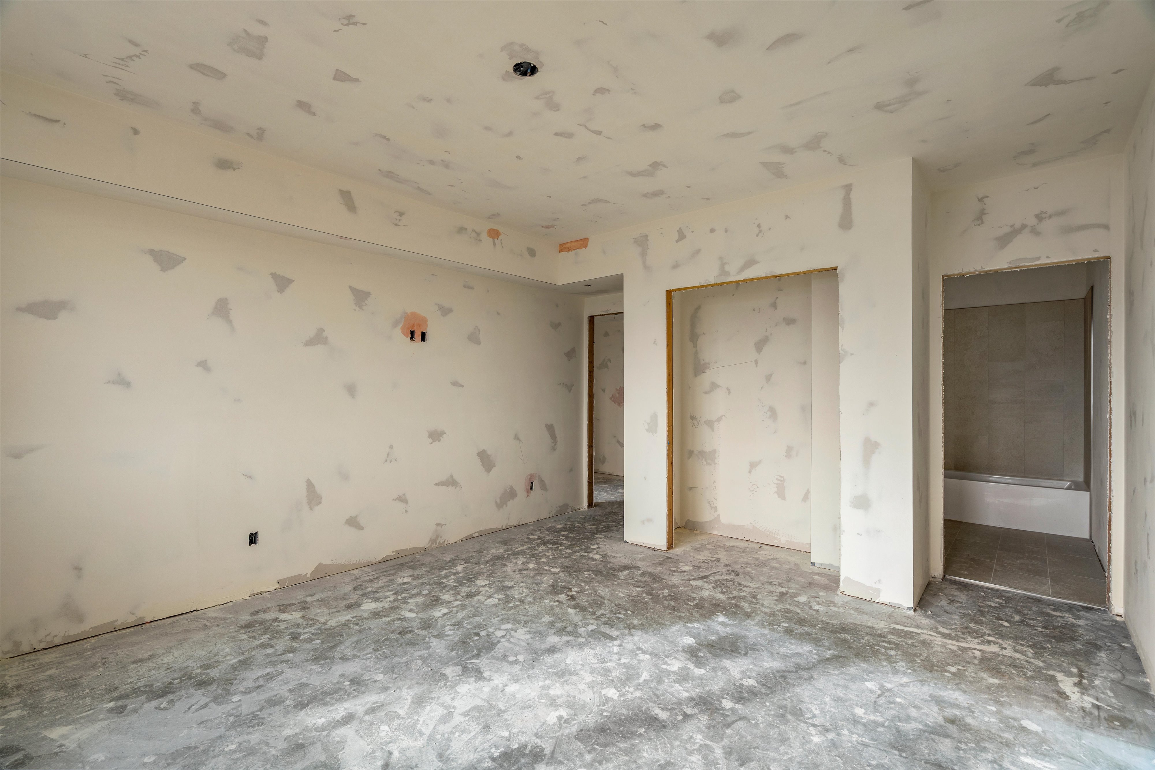 Unfinished interior space with smooth drywall-finished walls and ceiling
