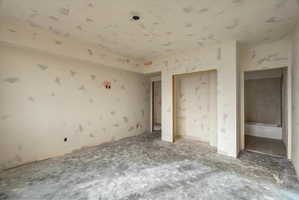 Unfinished interior space with smooth drywall-finished walls and ceiling