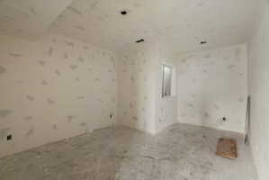 Unfinished room with natural light, featuring a single window, recessed lighting rough-ins, and a concrete floor