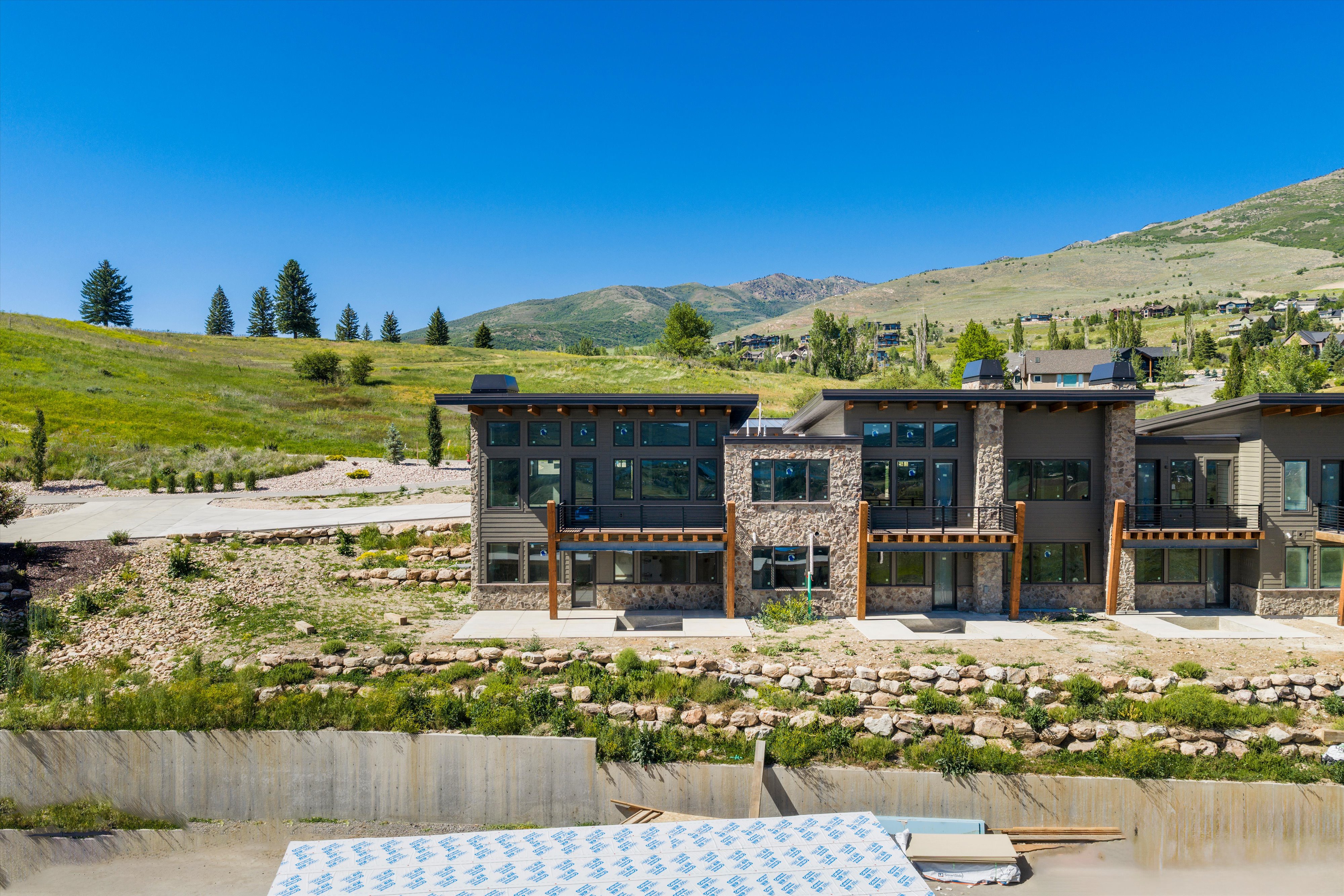 Modern multi-story residences featuring stone and siding exteriors