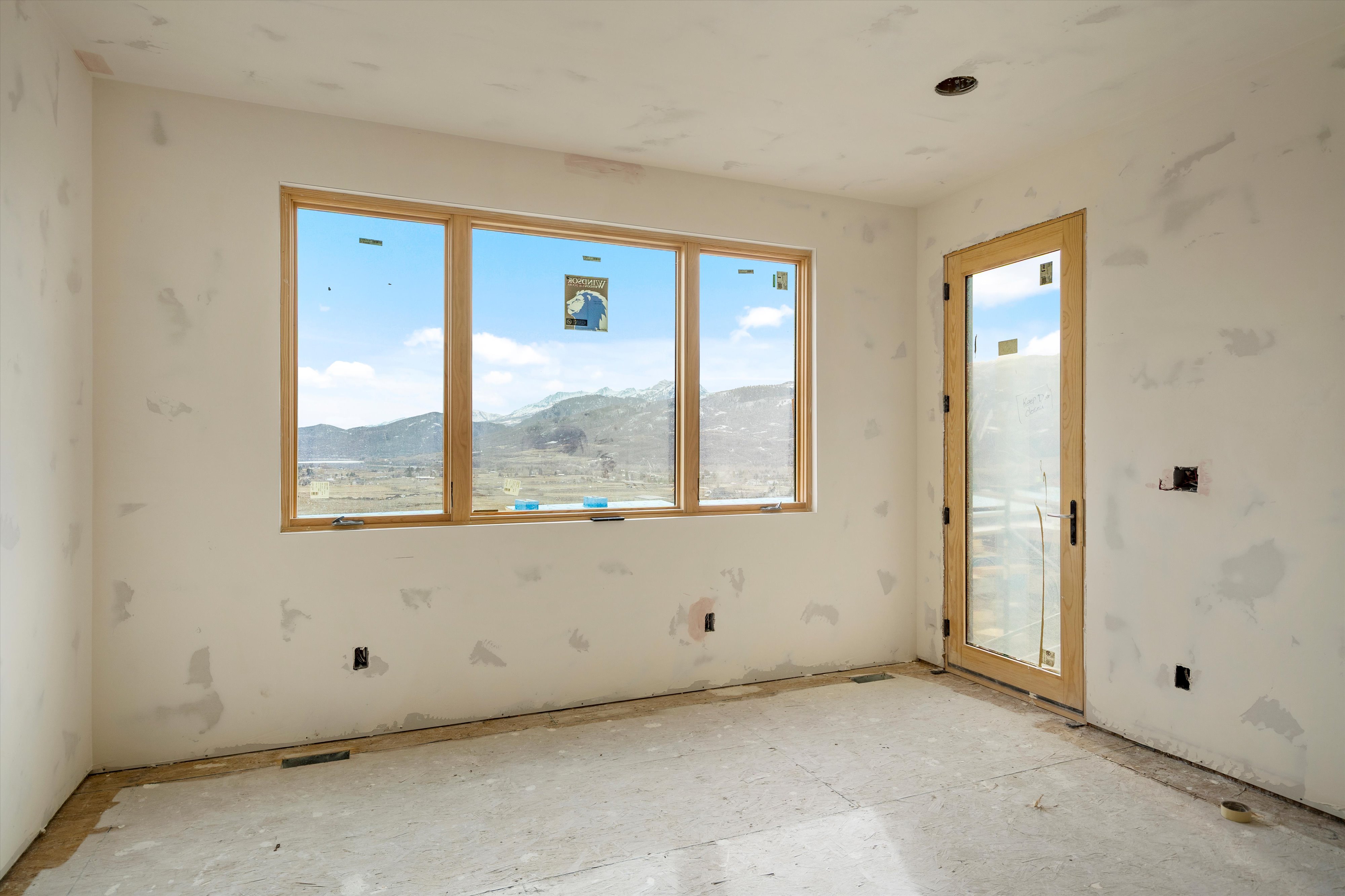 Large window framing a mountain and valley landscape