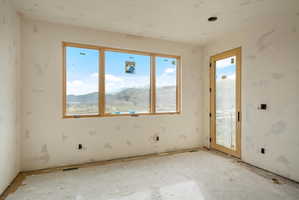 Large window framing a mountain and valley landscape