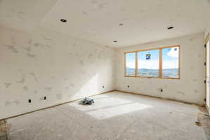 Spacious room with large triple-pane windows showcasing expansive mountain scenery