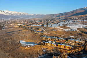 Snowy aerial view with a mountain view and a residential view