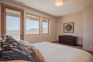 Bedroom with access to exterior and a mountain view