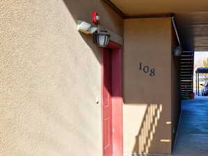 Entrance to property with stucco siding