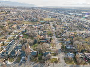 Aerial view of property's location with nearby suburban area and a mountainous background