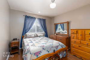 Bedroom with wood finished floors and baseboards