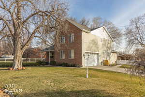 View of side of home with driveway, an attached garage, and brick siding