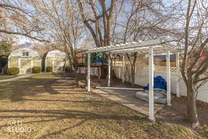 Fenced backyard with a pergola, a playground, and a shed