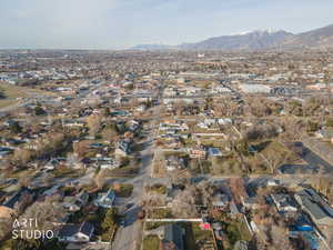 Aerial overview of property's location with nearby suburban area and a mountainous background