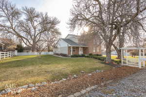View of side of property featuring brick siding and covered porch