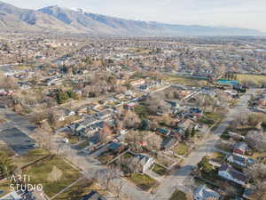 Aerial overview of property's location featuring nearby suburban area and a mountain backdrop